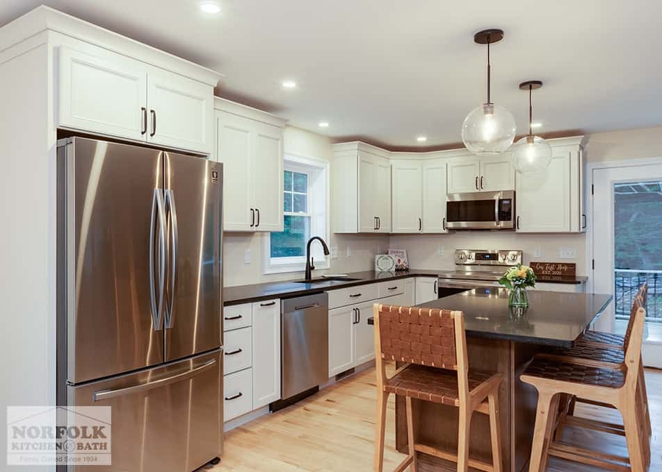 Hudson kitchen remodel with white shaker cabinets and stainless steel appliances and a wood stain island
