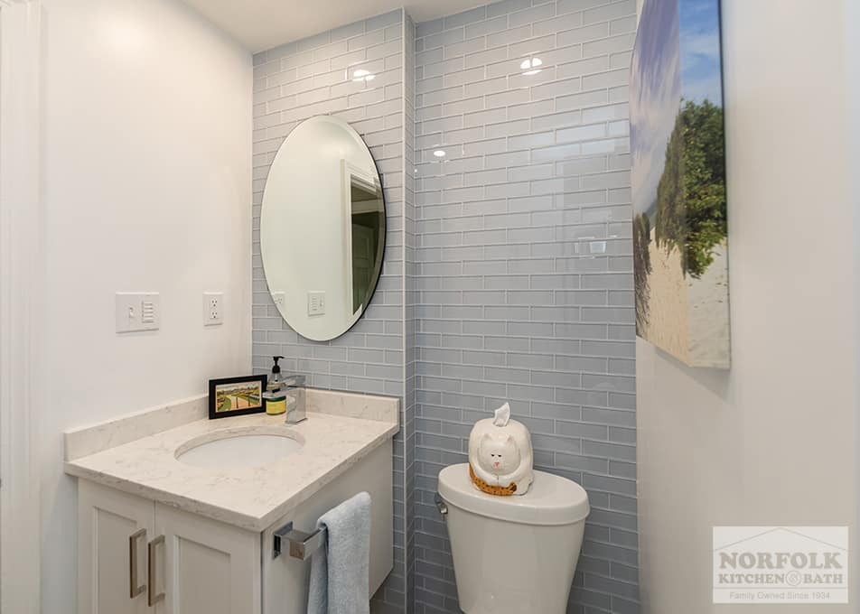 bath remodel in Quincy with a floating white vanity and blue-gray subway tile from floor to ceiling