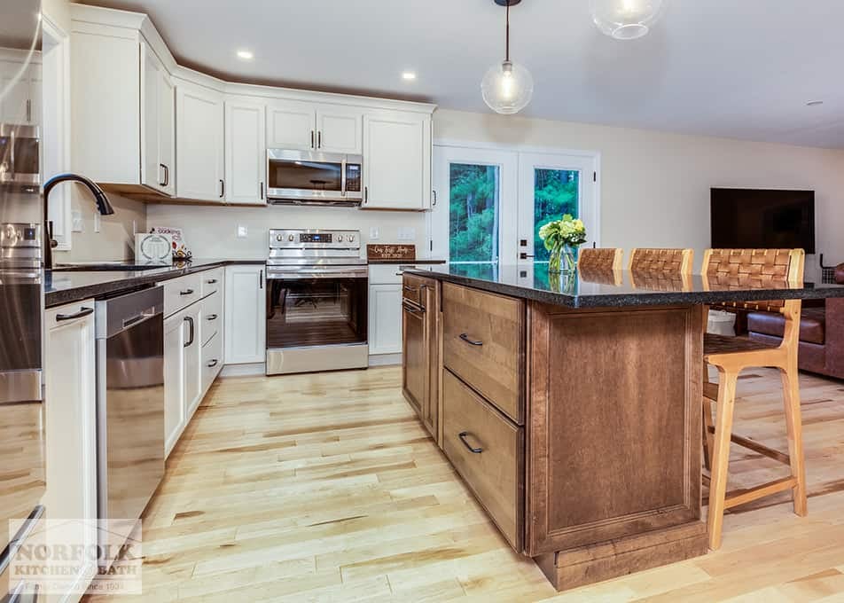 two tone kitchen remodel in Hudson with white shaker cabinets and a stained wood island with seating