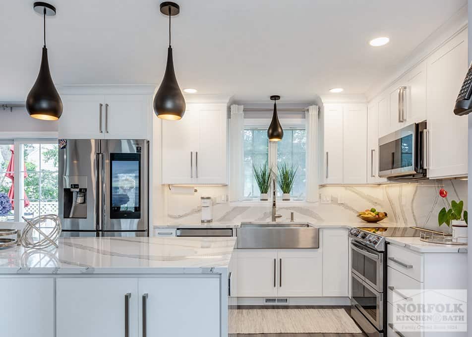 a kitchen remodel with classic white shaker cabinets and a quartz countertop