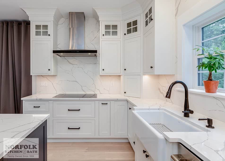 inset white kitchen cabinets with a white quartz kitchen countertop with marble-like veining