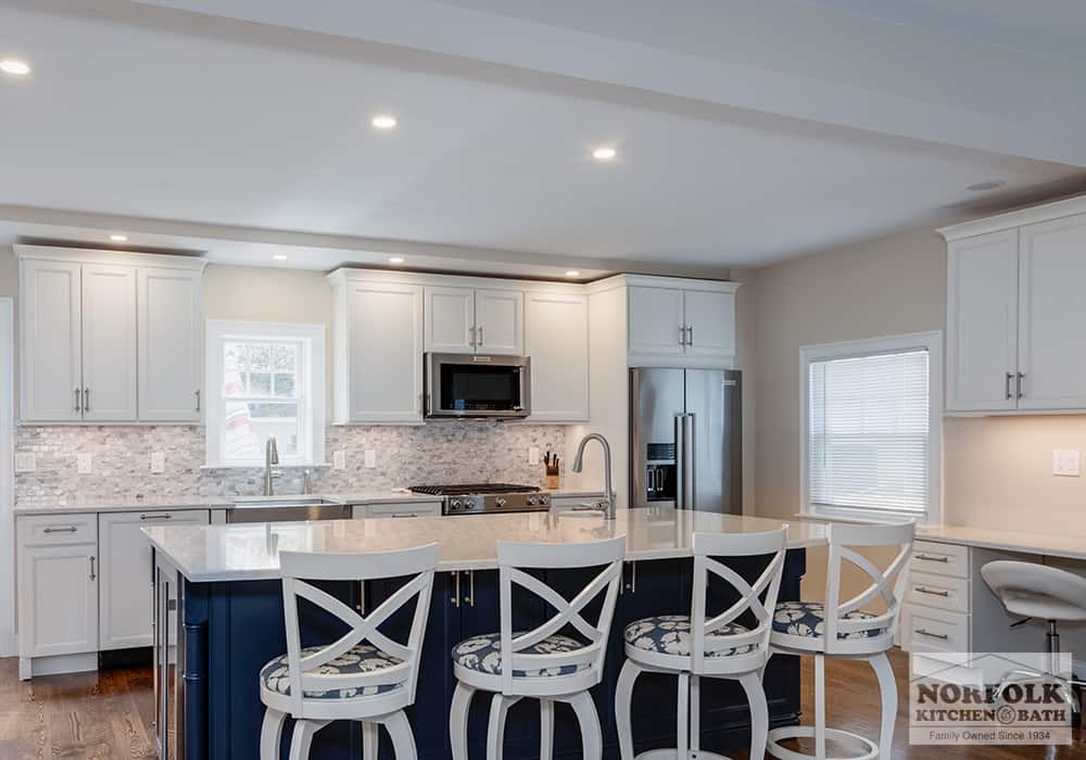 white kitchen remodel in Hull, MA with navy blue island and white desk area to the right
