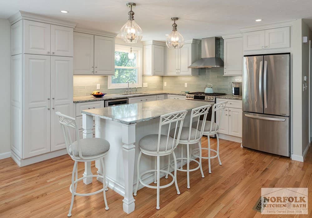 traditional white kitchen remodel with raised panel kitchen cabinets and quartz countertops with an island