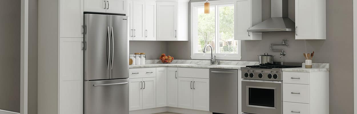white shaker kitchen with laminate countertops and stainless steel appliances