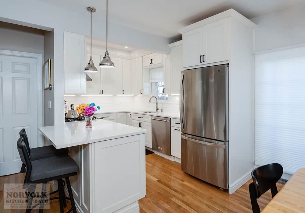 white kitchen remodel in Boston, MA with quartz countertops and a peninsula
