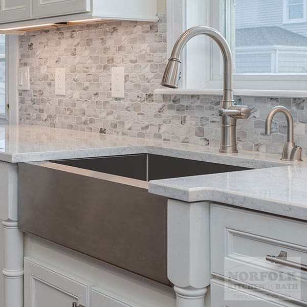 Stainless Apron sink in a white kitchen with a satin nickel faucet
