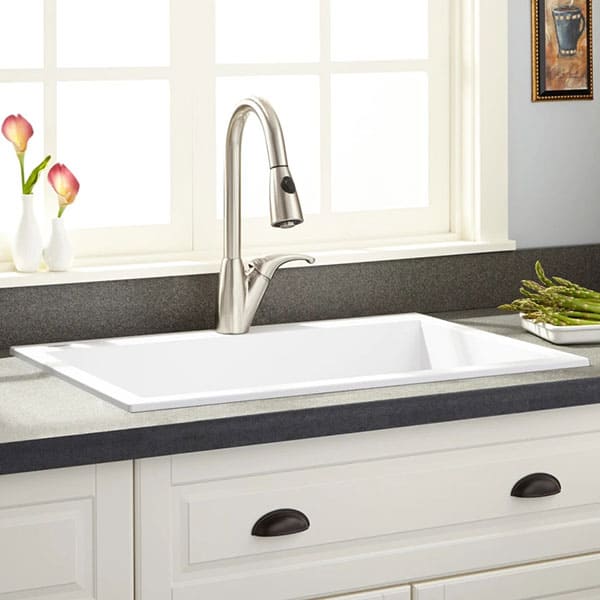 white drop in kitchen sink with faucet