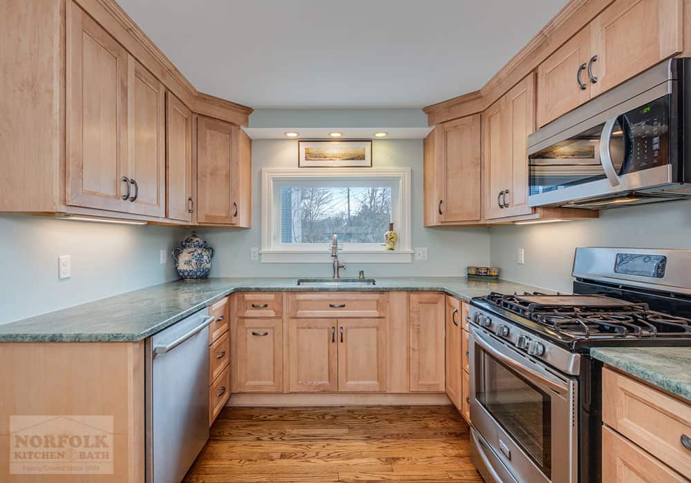 small U-shaped kitchen remodel with a maple stained kitchen cabinet and stone countertops