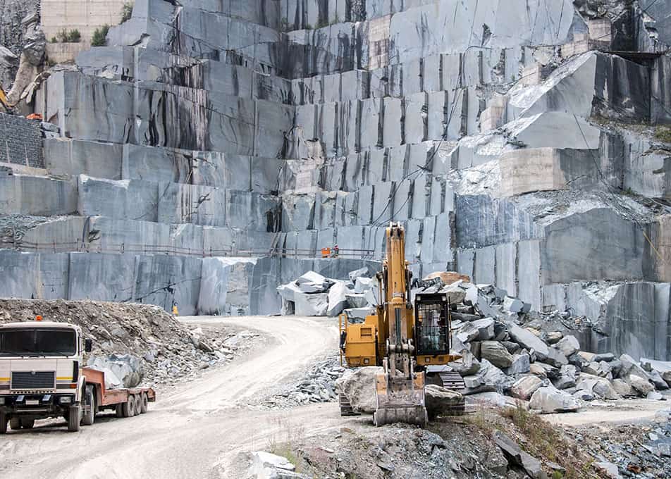 a large granite quarry with an excavator