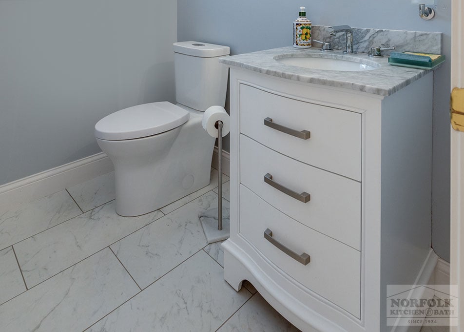 powder room bath remodel with a small white vanity and toilet